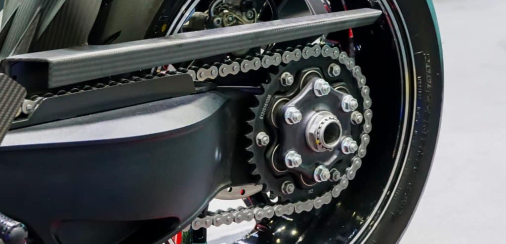 The rear chain and sprocket of a motorcycle wheel.